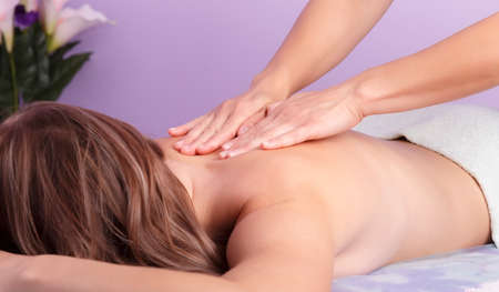 Hands of masseur doing massage of spine in a salonの写真素材