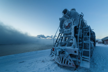 Old steam locomotive in winter covered with hoarfrostの写真素材