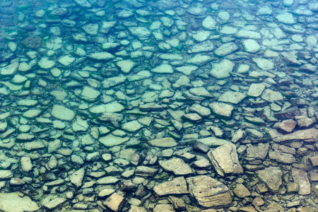 Background of transparent sea water and bottom with stonesの写真素材