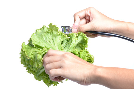 Headphones and vegetables on a white background. の写真素材