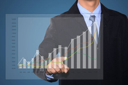 Business man hand drawing a graph の写真素材