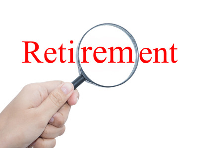 Hand Showing Retirement Word Through Magnifying Glass の写真素材