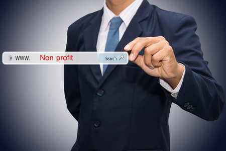 Business and technology, searching system and internet concept - male hand pressing Search Non profit button. Business and technology, searching system and internet concept - male hand pressing Search Non profit button.