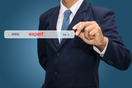 Business and technology, searching system and internet concept - male hand pressing Search expert button. の写真素材