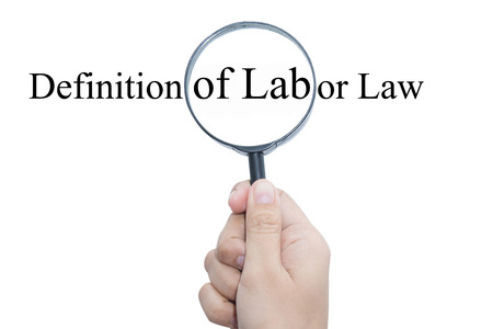 Hand Showing Definition of Labor Law Word Through Magnifying Glass の写真素材