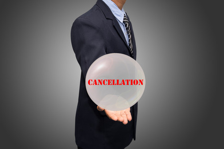 business man writing CANCELLATION conceptの写真素材