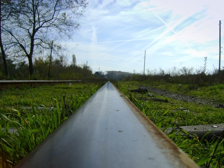 Right railroad tracks leading into the distance.の写真素材