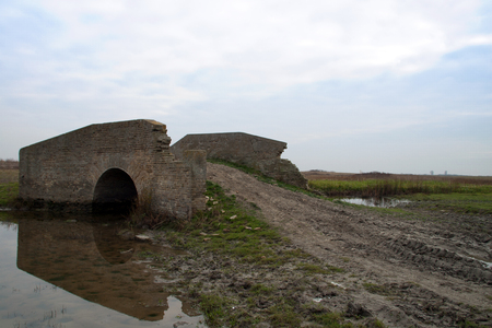 The old bridge of bricks that there is far away from the village and farmers who use to go to the farm.の写真素材