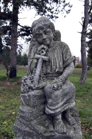 The monument, a figure in the village cemetery.の写真素材