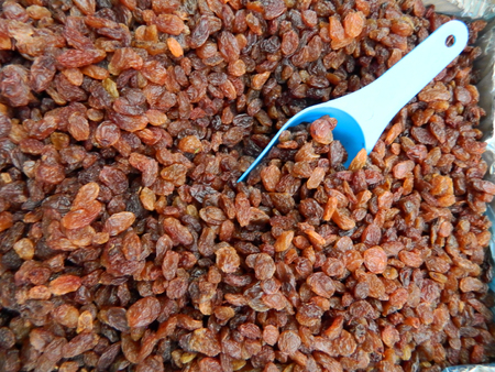 A larger quantity of sweet and tasty raisins on market stall waiting for customers.の写真素材