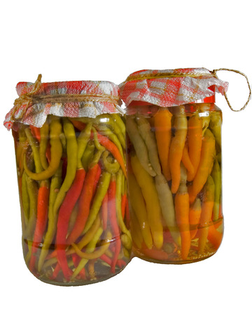 Two jars with homemade colorful hot peppers.の写真素材