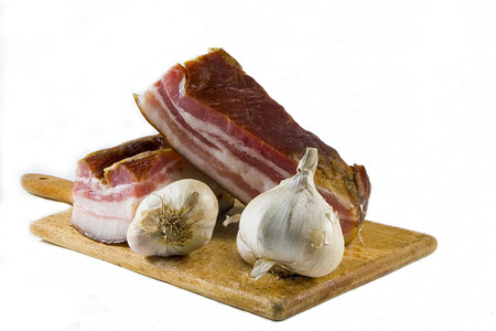 Domestic bacon and garlic on wooden kitchen board.の写真素材