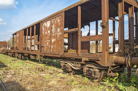 Old railway wagon on siding and waiting to cassation or repair.の写真素材