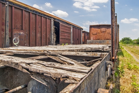 Old railway wagon on siding and waiting to cassation or repair.の写真素材