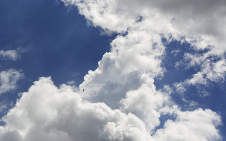 Summer day and the white clouds that travel blue sky.