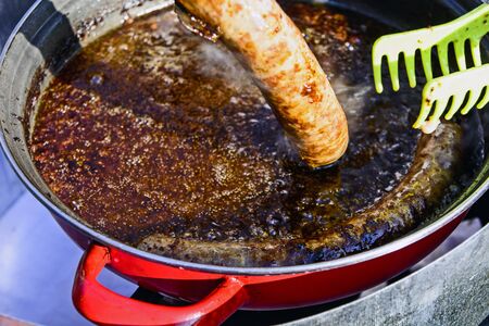 The traditional roast sausage in a special container in the open.の写真素材