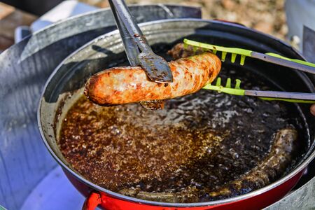The traditional roast sausage in a special container in the open.の写真素材