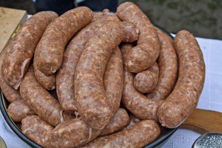 Freshly produced sausages cooked in a bowl and cooked for baking and selling.の写真素材