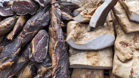 Various products from dried meat exposed to view and tasting before sale.の写真素材