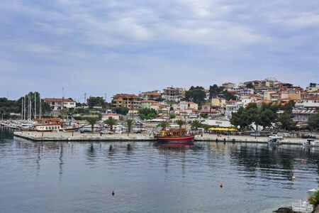 Neos Marmaras, Greece, May 30, 2019. A view of a quiet city harbor with ships.のeditorial素材