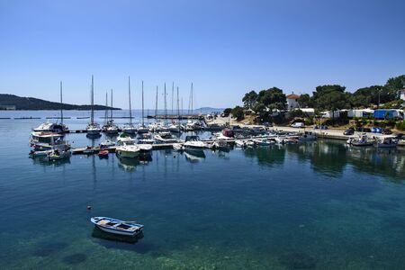 Neos Marmaras, Greece, May 30, 2019. A view of a quiet city harbor with ships.のeditorial素材