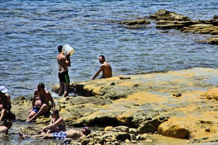 Evia Island, Loutra Edipsou, Greece, Jun 05, 2016.Enjoying tourists in the warm medicinal spa water that springs from the rocks on the Aegean coast.のeditorial素材