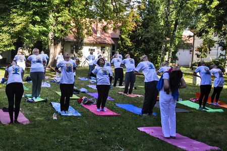 Zrenjanin, Serbia, Jun 16, 2019. A group of people meditation in honor of the World Day of Yoga.のeditorial素材