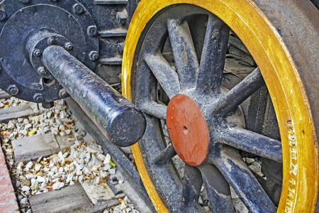 Kikinda, Serbia, October 17, 2015. The front wheel of an old steam locomotive with operating cylinder.のeditorial素材