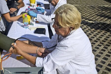 Zrenjanin, Serbia, September 29, 2019. Doctors in the action of preventive control of diabetes outdoors in the visitors of a large shopping center.のeditorial素材