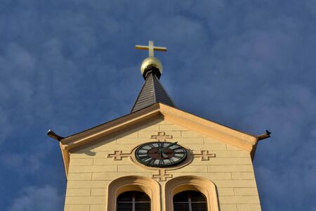 Zrenjanin, Serbia, September 27, 2019. The church tower of the Catholic church in the center of the city is sunlit.のeditorial素材