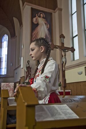 Ivanovo, Serbia, April 09, 2017. A young girl in a Catholic cathedral before the start of the Mass.のeditorial素材
