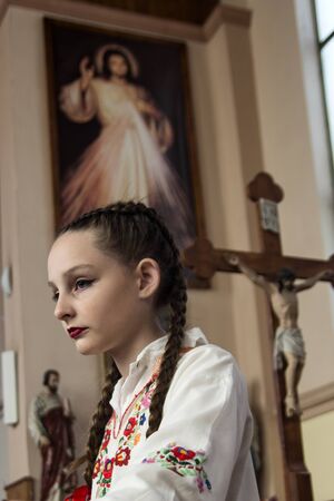 Ivanovo, Serbia, April 09, 2017. A young girl in a Catholic cathedral before the start of the Mass.のeditorial素材