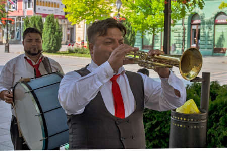 Sombor, Serbia, June 13, 2020. A group of street musicians entertains passers-by every day. They play folk and other music as needed. They charge for their services immediately.のeditorial素材
