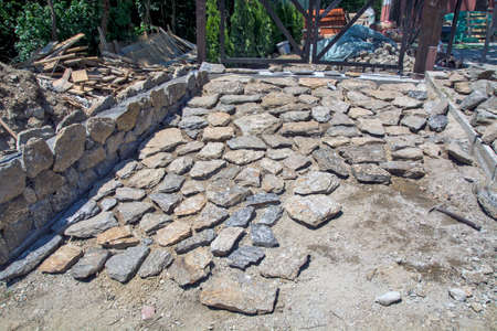 The traditional strong and solid entrance to the yard is made of stone. The Masters are currently on break.の写真素材