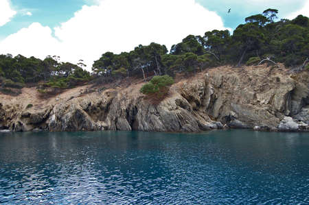 A beautiful deserted uninhabited island near Neos Marmaras in Greece. Birds nest on the island and the island got the name Turtle because its shape, from afar, resembles a giant turtle.の写真素材
