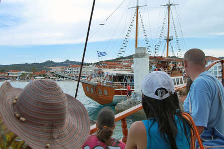 Aegean Sea, Greece, June 08, 2013. Tourists sail on an old ship in Greece between Pefkochori and Neos Marmaras. The boat is full of tourists who enjoy a beautiful day and calm sea.のeditorial素材