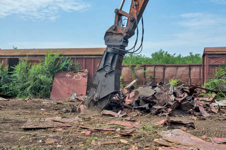 Zrenjanin, Serbia, August 31, 2020. Cutting of old railway wagons on the plateau of the station. The cut parts are transported to the ironworks for recycling. Cutting is done with a special machine.のeditorial素材
