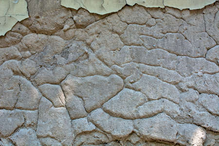 An old house with an old dilapidated facade on the house. The facade is cracked and peeling.の写真素材