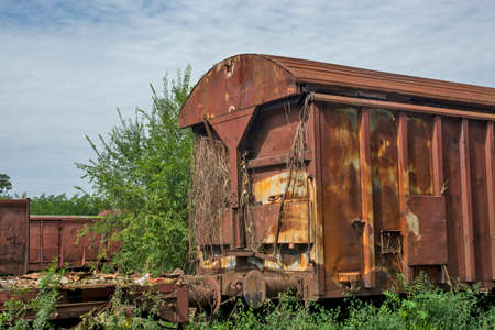 Old freight railway wagons that have expired and are waiting to be serviced or cut.の写真素材