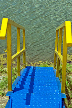 Beautiful and strong blue metal steps leading to the water. Stairs have been installed for easier and safer access to water.の写真素材