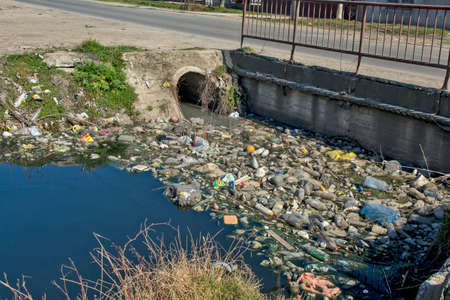 Zrenjanin, Serbia, March 01, 2021. Picture of human negligence and ecological catastrophe on the canal with water and its surroundings. Every life in the water is gone and the stench is spreading.のeditorial素材