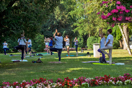 Zrenjanin, Serbia, June 19, 2021. Celebrating World Yoga Day in the city hall park. Yoga is practiced and meditated in nature. This location has traditionally marked World Yoga Day for many years.のeditorial素材