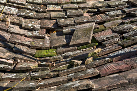 Old tile on the roof of the auxiliary building of the rural household.の写真素材