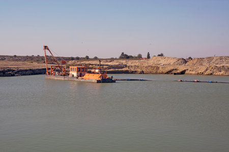 A large navigable floating dredger extracts industrial sand from the bed.の写真素材