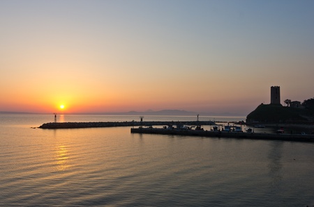 Sunrise at a little fishing harbour in Greeceの写真素材