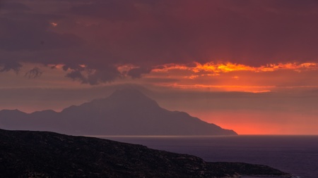 Stormy sky and sunrise at holy mountain Athos in Greeceの写真素材