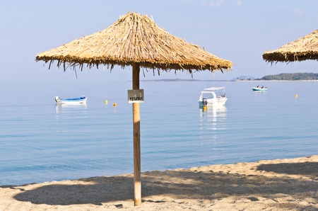 Thatched sunshade on a beach reserved for you, Macedonia, Greeceの写真素材
