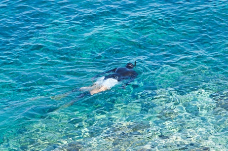 Diver or snorkler at Aegean sea near small greek island, Macedonia, Greeceの写真素材