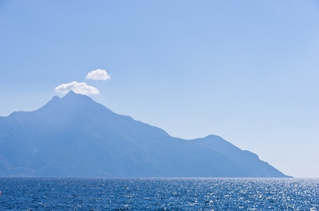 Aegean sea, silhouette of the holy mountains Athos and a small cloud above the mountain top, Chalkidiki, Greeceの写真素材