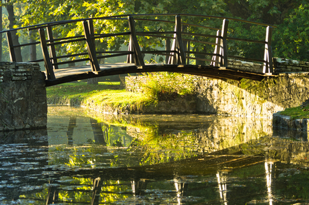 Little wooden bridge on first sunrays at morning in Topcider parkの写真素材